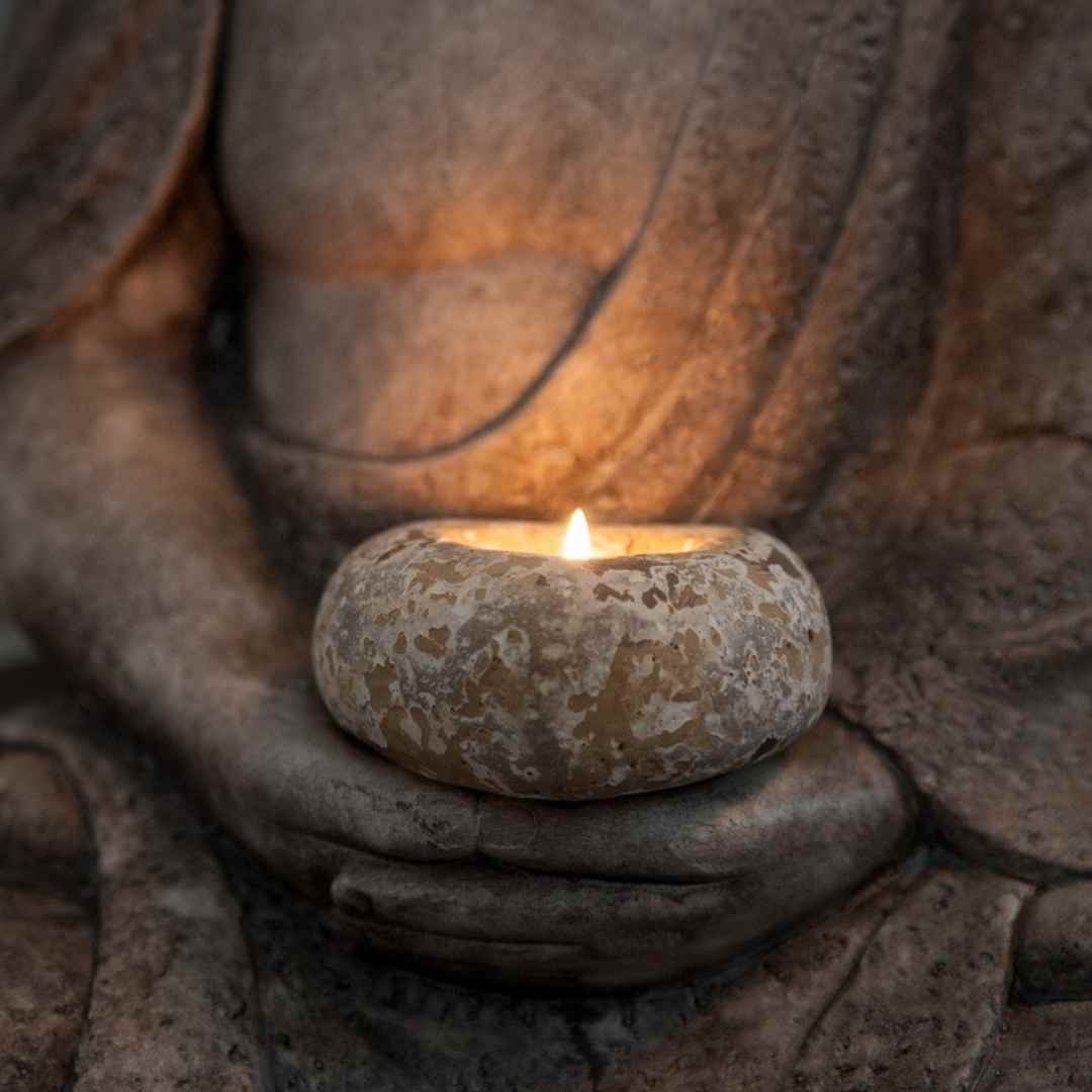 Buddha holding a candle