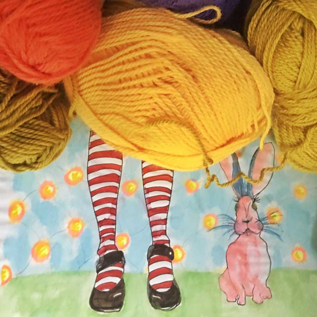 Drawing of Alice in Wonderland legs with mad hatter bordered by yarn